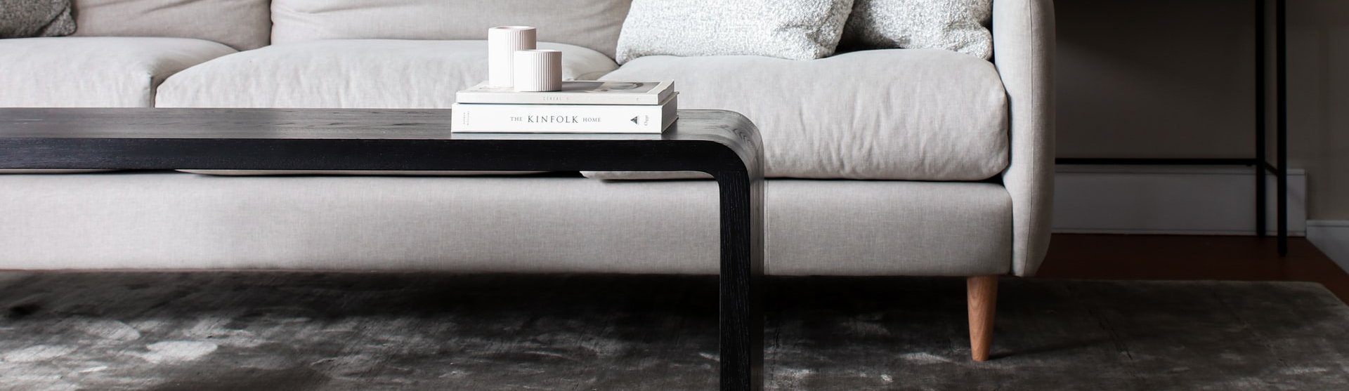 white couch and black coffee table on a brown hardwood floor from Lonsdale Flooring in Vancouver, BC
