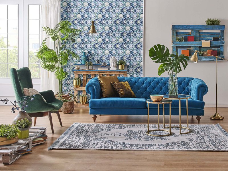 blue couch and green armchair on a patterned rug from from Lonsdale Flooring in Vancouver, BC